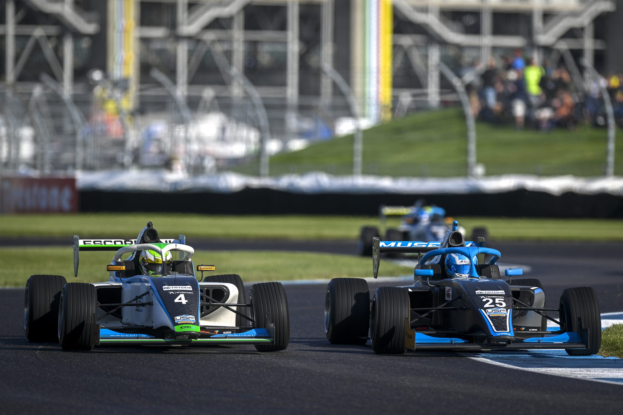 The No. 25 car alongside another car on the Indianapolis Motor Speedway road course.