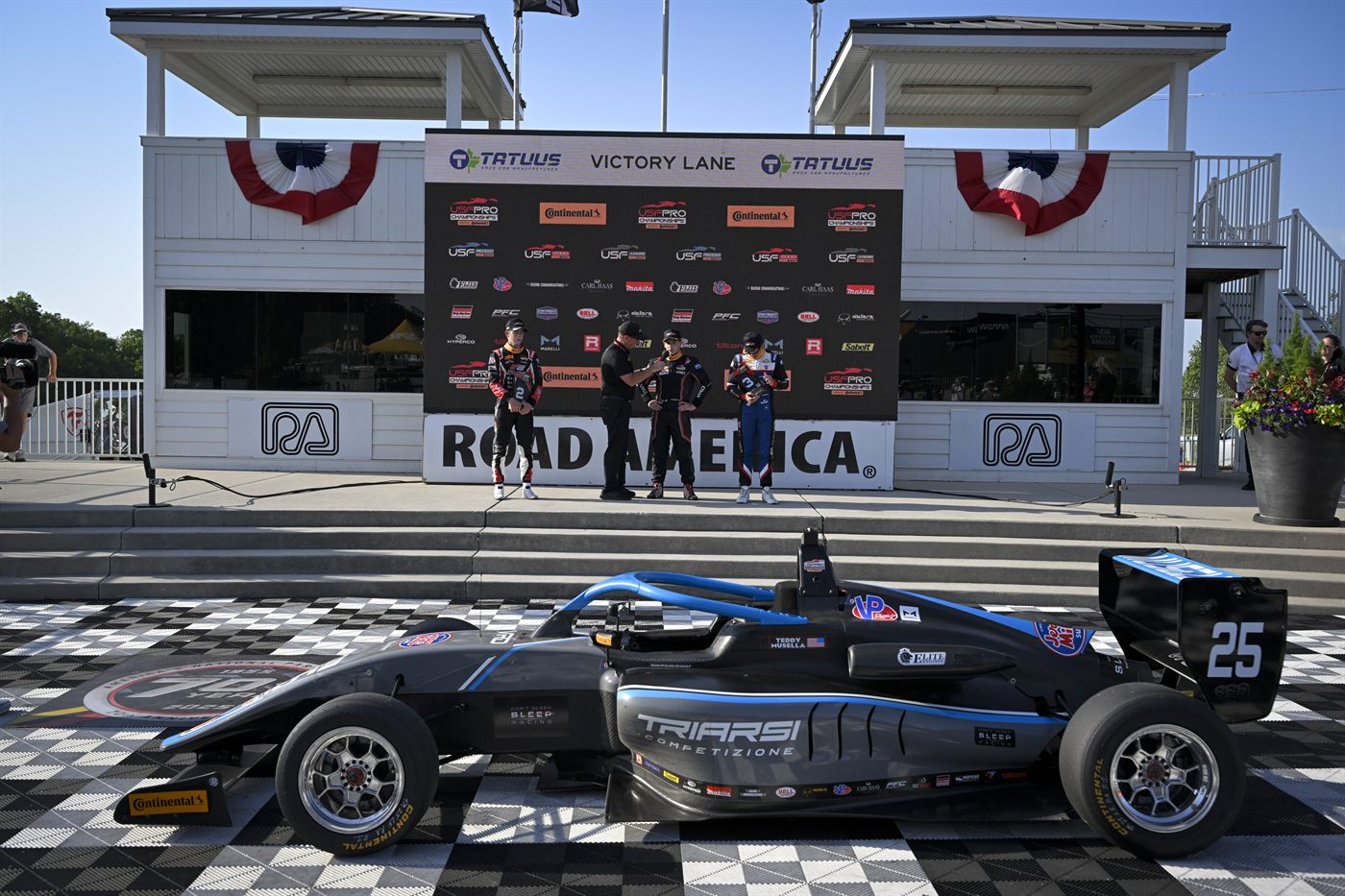 The No. 25 car parked on the checkered surface of Victory Lane at Road America.